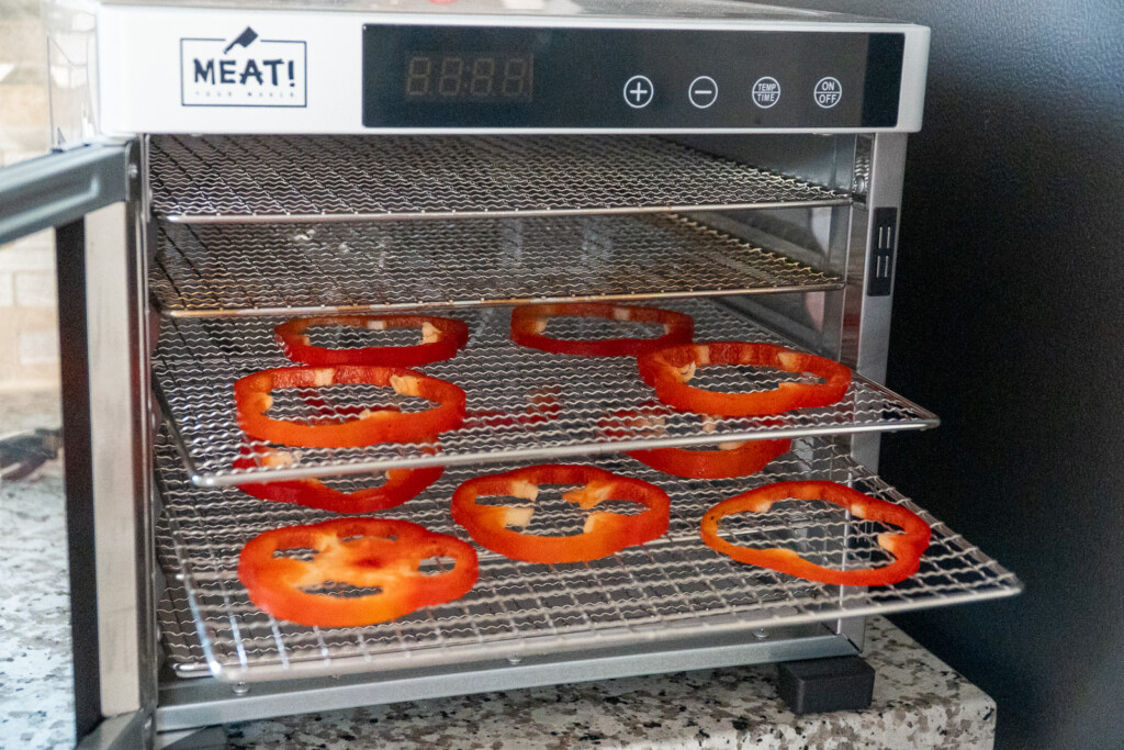 sliced of smoked bell pepper in the dehydrator