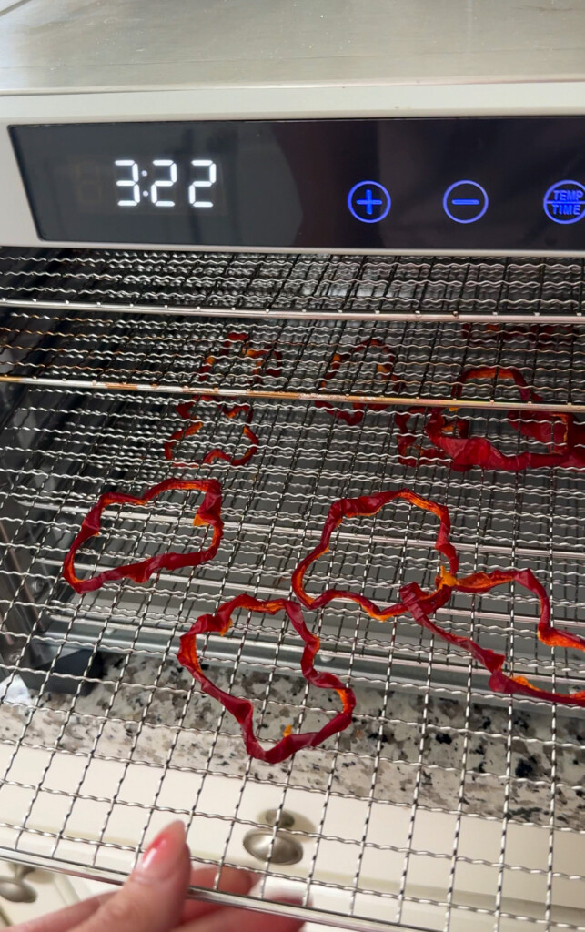 red bell peppers dehydrated on wire racks