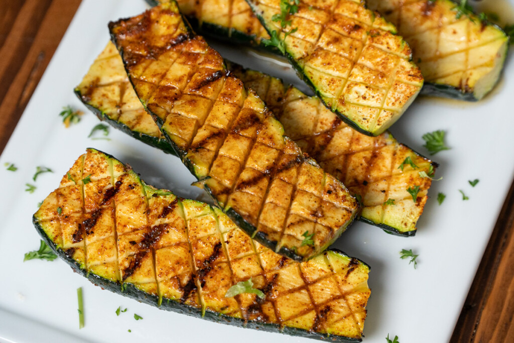cooked grilled zucchini on a white plate