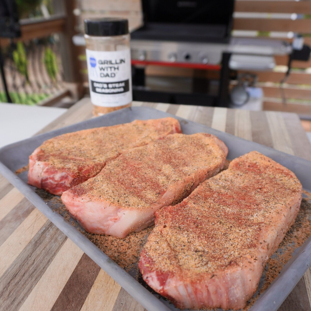 seasoned NY strip steaks.