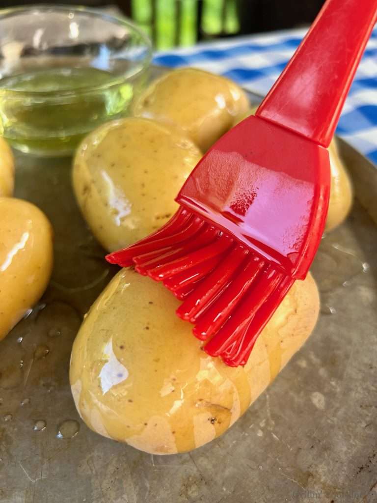 Brushing oil on Potatoes