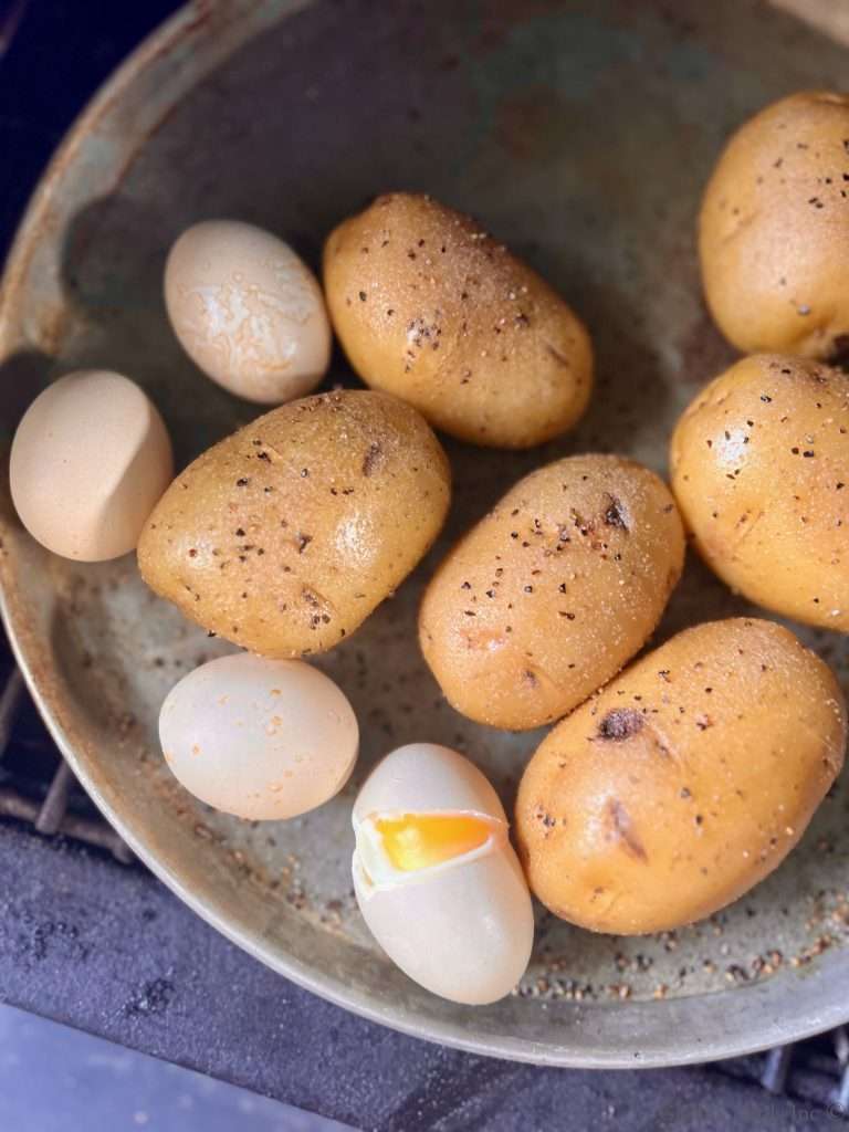 Smoked Potatoes and Eggs, one Cracked