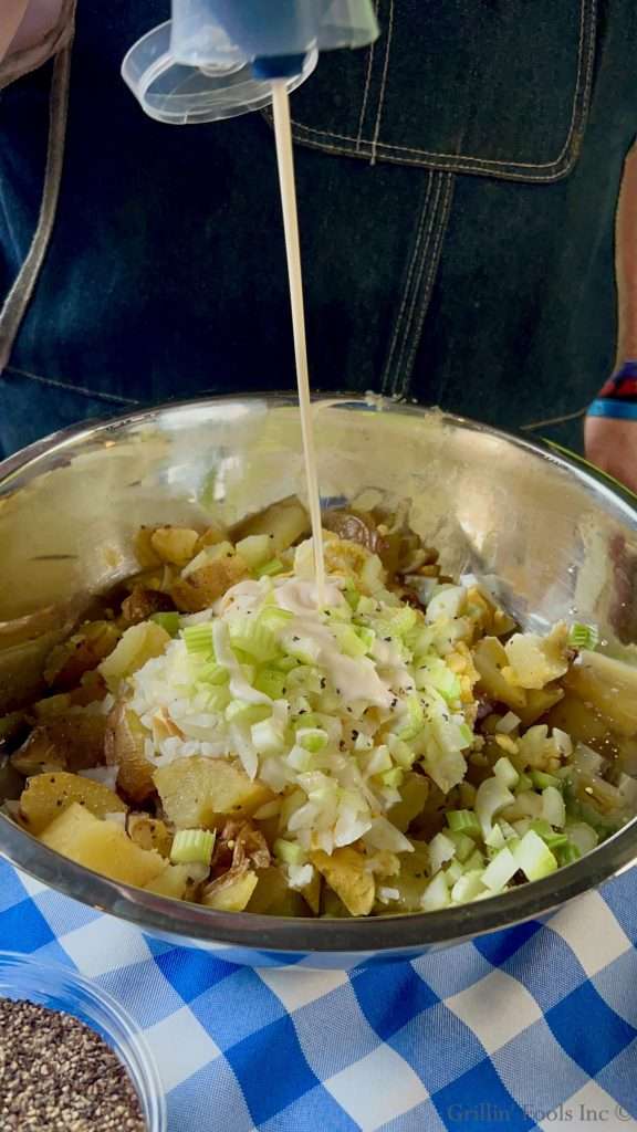 Adding Garlic Aioli to the Smoked Potato Salad