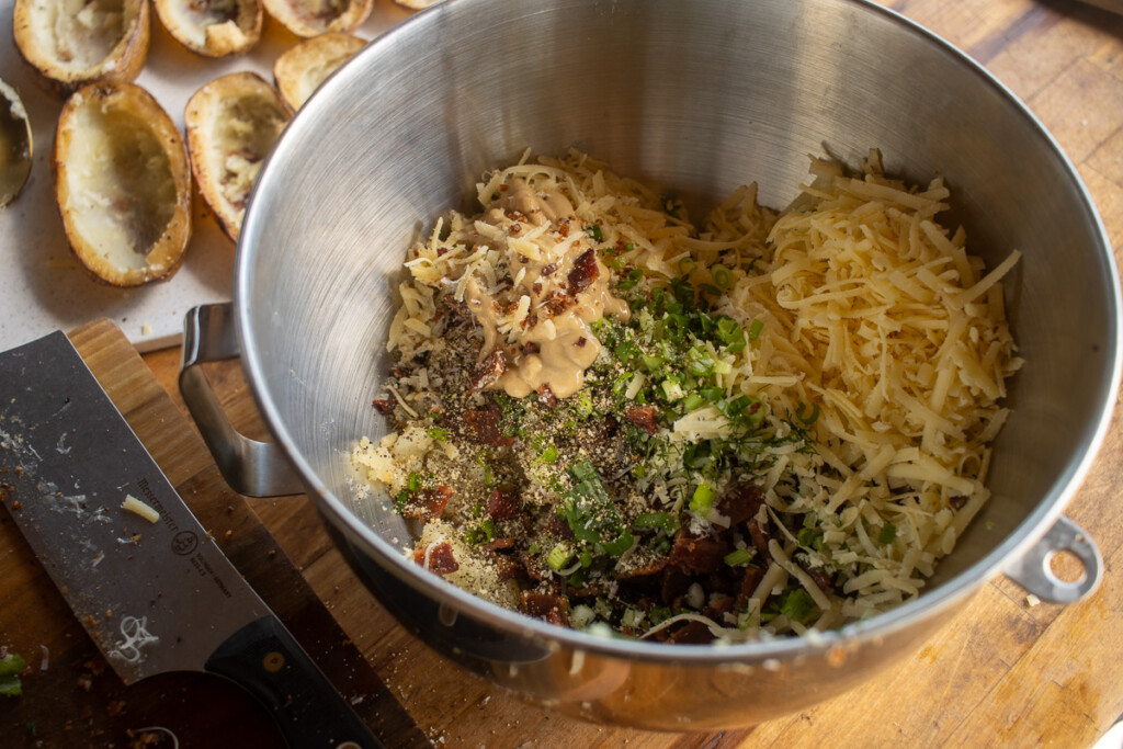 a metal bowl of unmixed potatoe filling