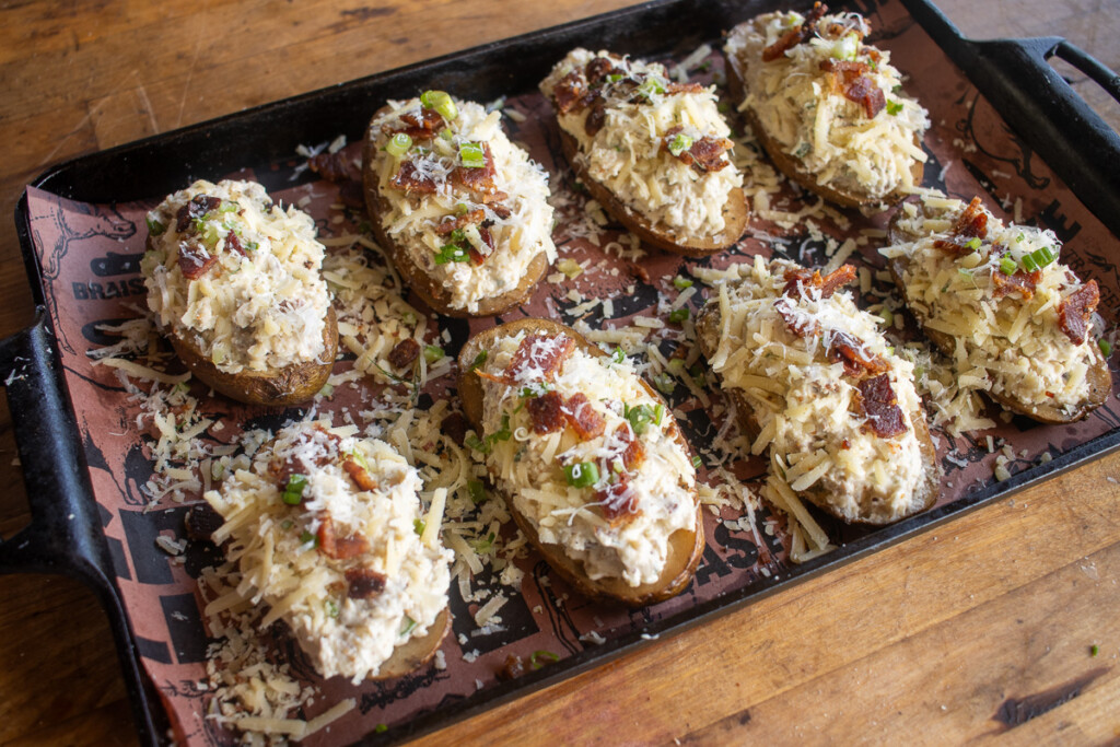 loaded baked potatoes ready to go into the smoker for the second time