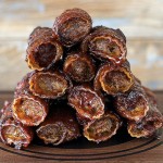 smoked shotgun shells stacked on wood serving block