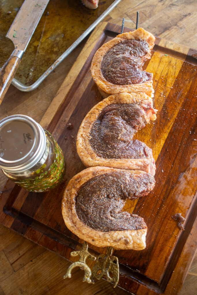 three picanha steaks, curled and skewered