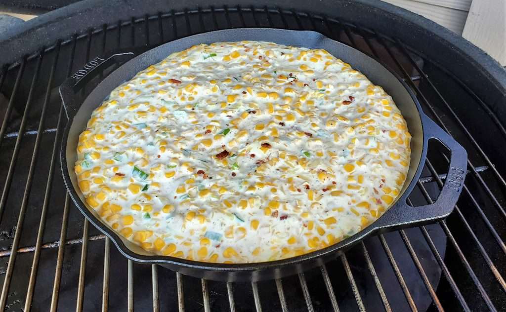 Jalapeno popper corn dip in cast iron skillet on the grill