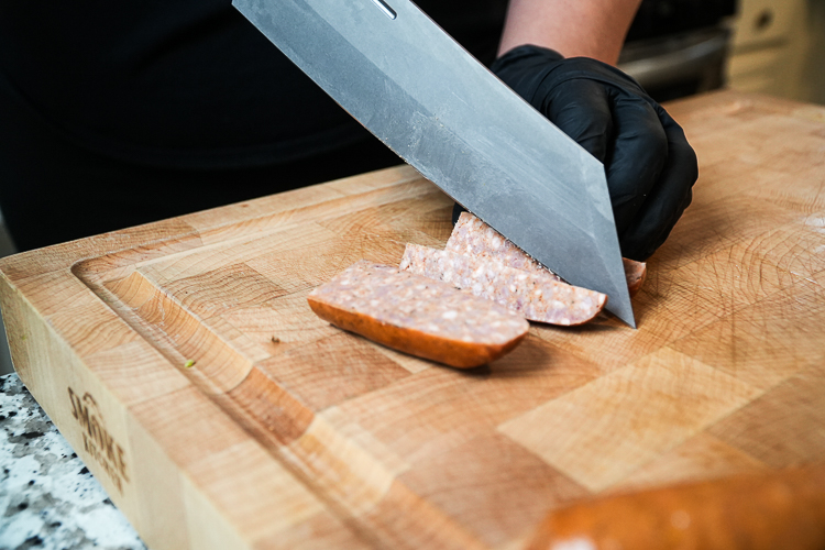 Cutting smoked sausage into quarters