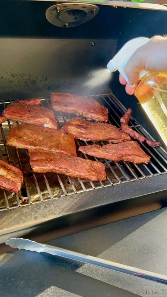 Spritzing Party Ribs with Water and Apple Cider Vinegar