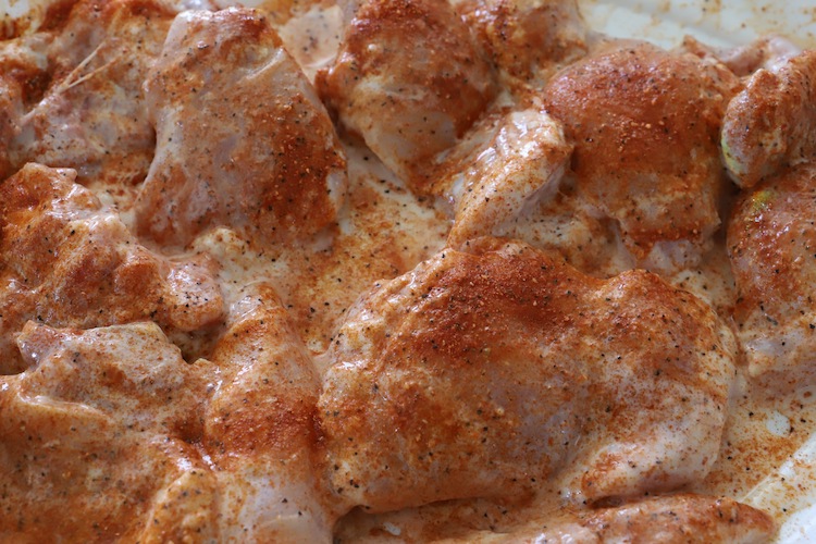 a rub applied over uncooked chicken thighs