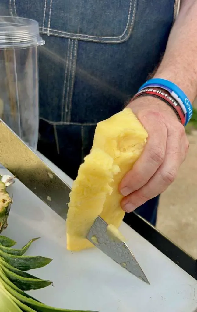Slicing off the soft Pineapple