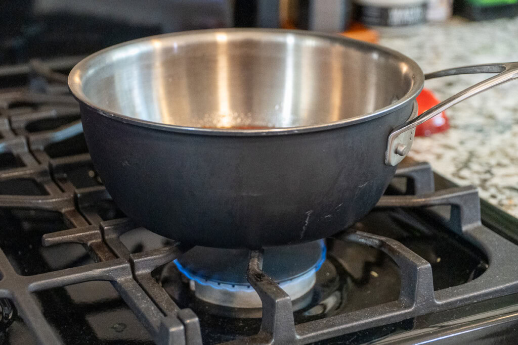 a saucepan sitting over a gas hob