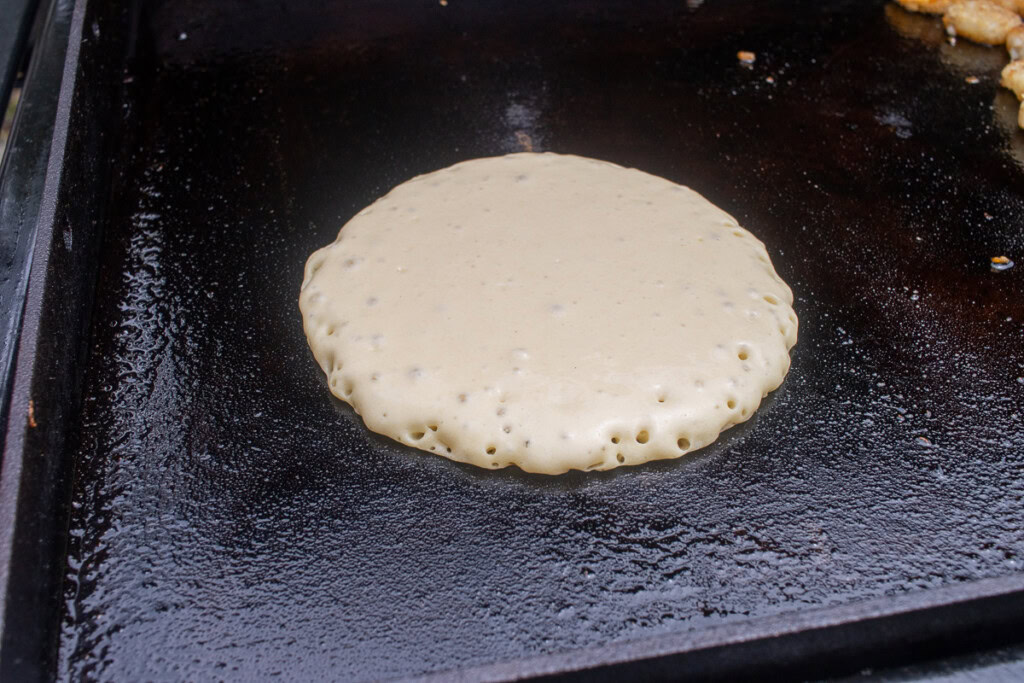 a perfect raw pancake on a hot griddle
