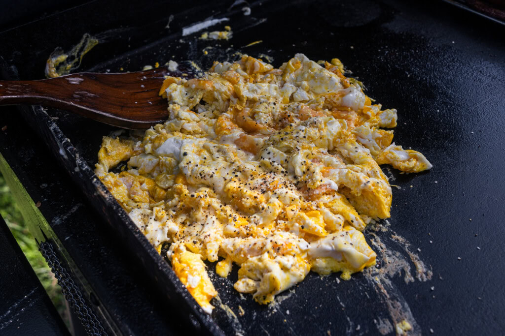 cooked scrambled eggs with cream cheese on the griddle