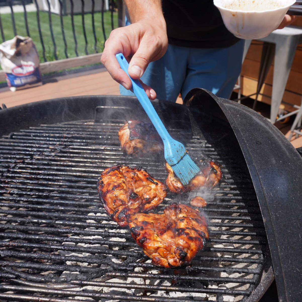 brushing grilled chicken with the best marinade.