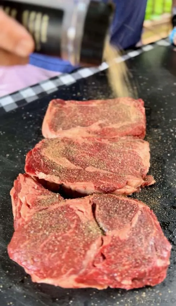 Seasoning the other side of the steaks