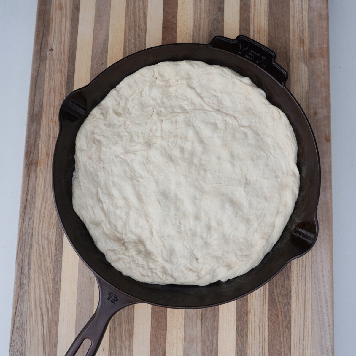 raw dough in a yeti cast iron skillet.