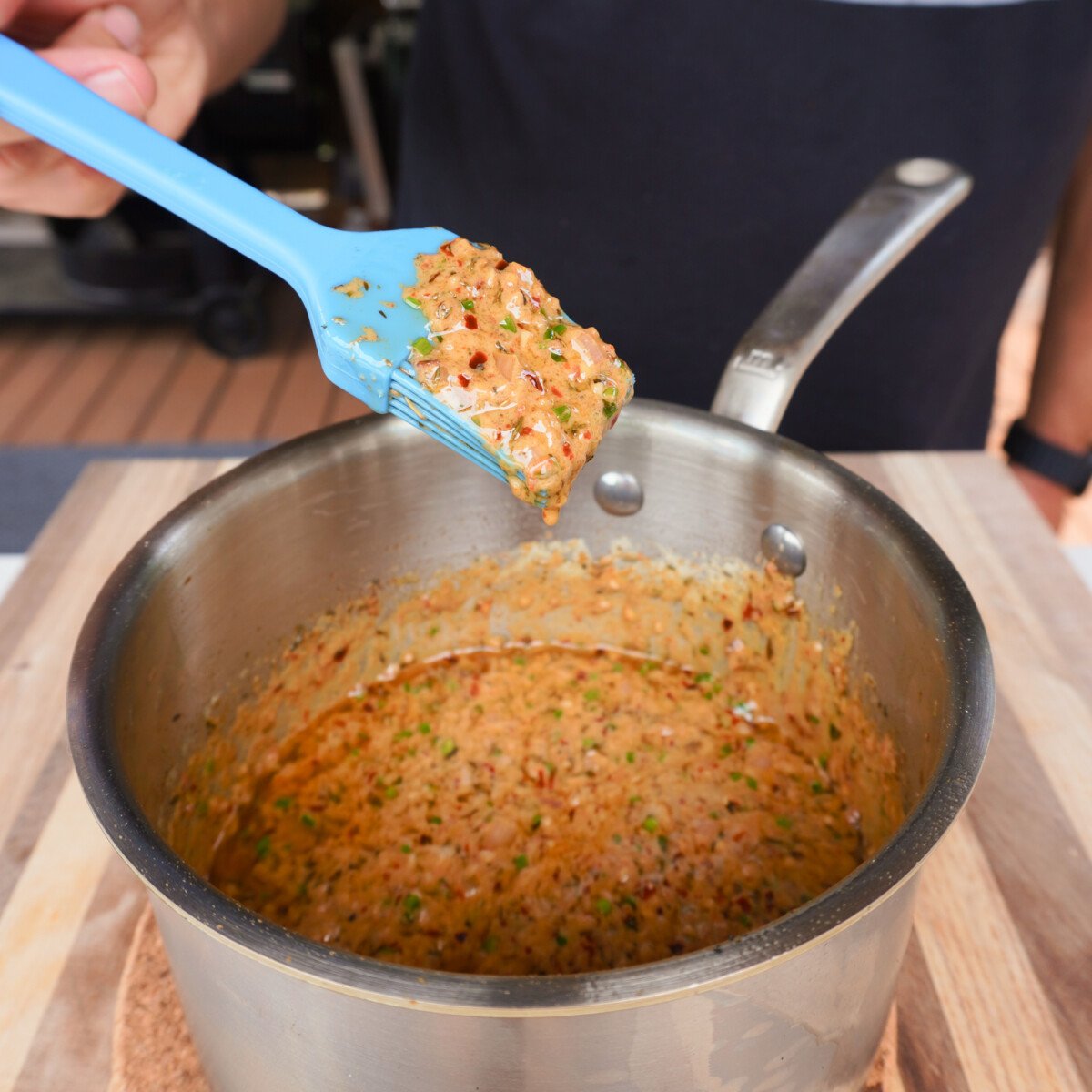 cowboy butter sauce cooked in a sauce pan with a brush showing the consistency.