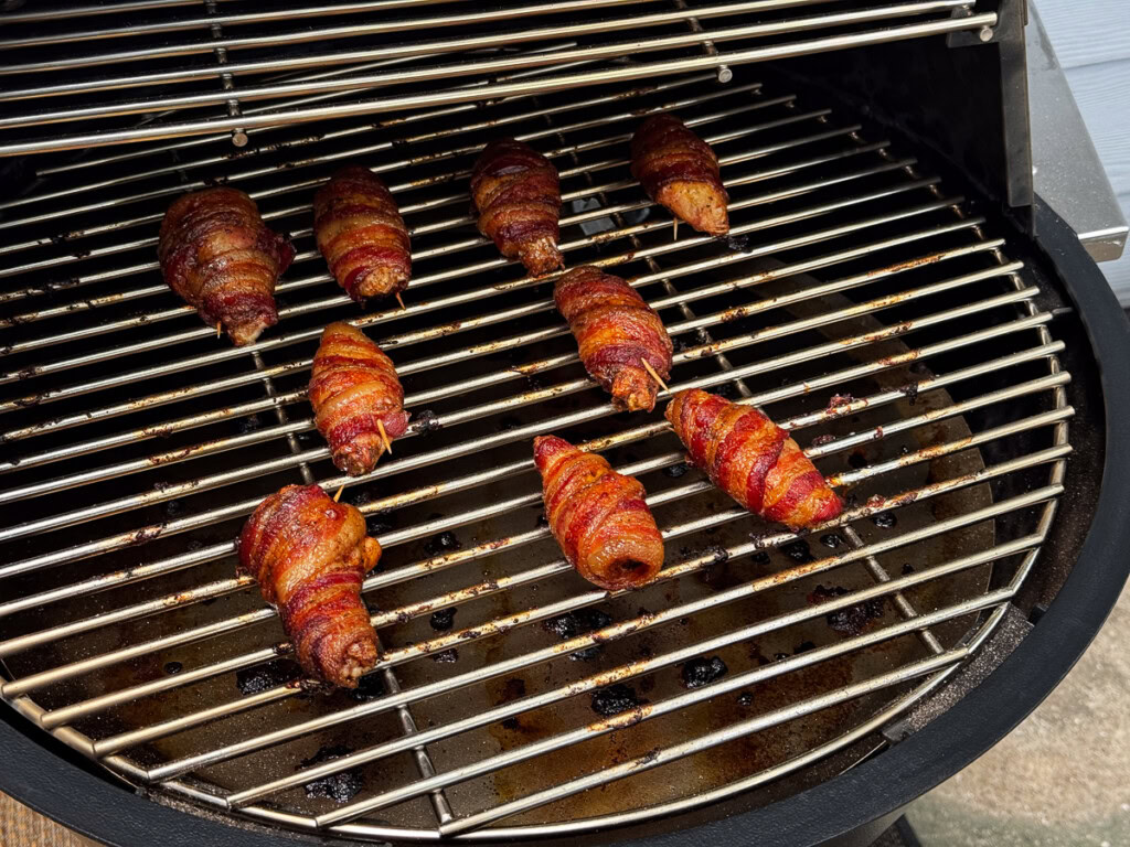 cooked bacon wrapped chicken wings on the grilla grill
