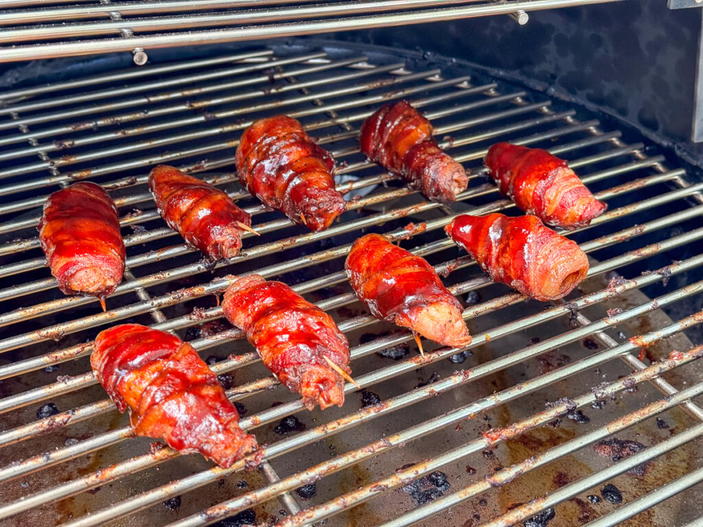 sauced bacon wrapped chicken wings on the grilla grill