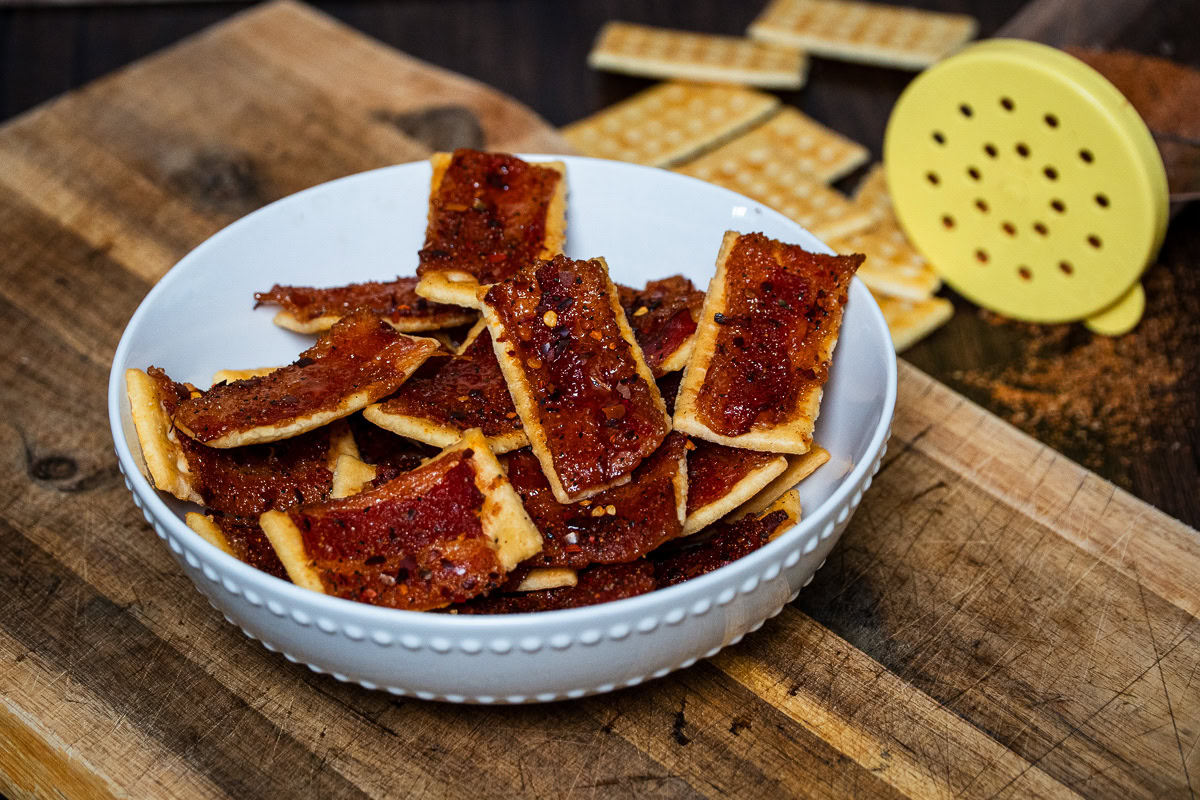 a white bowl of smoked billionaire bacon crackers