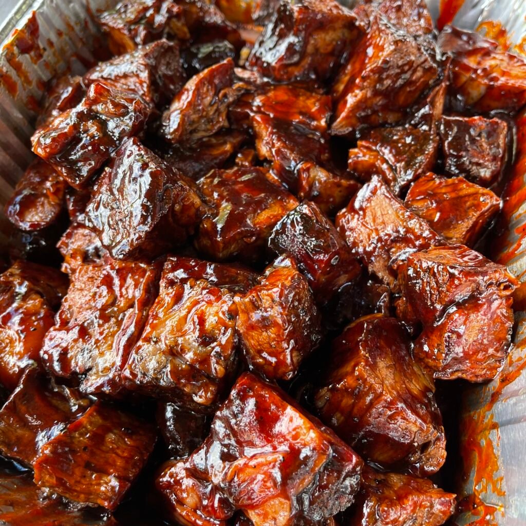 saucy cubed burnt ends in foil pan.
