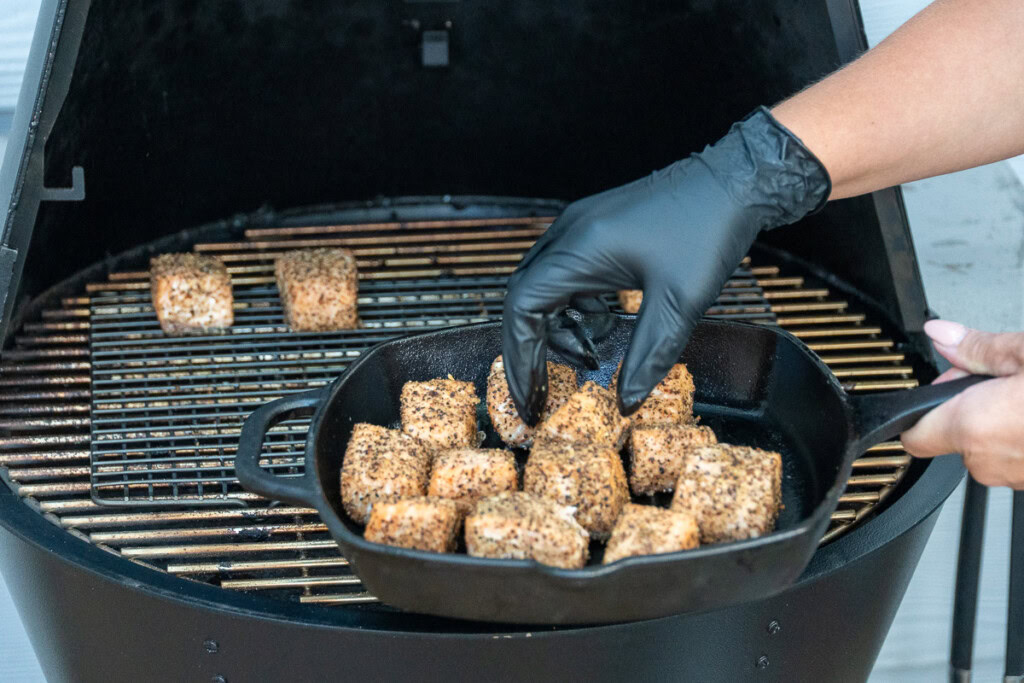 a cast iron pan full of cooked salmon cubes