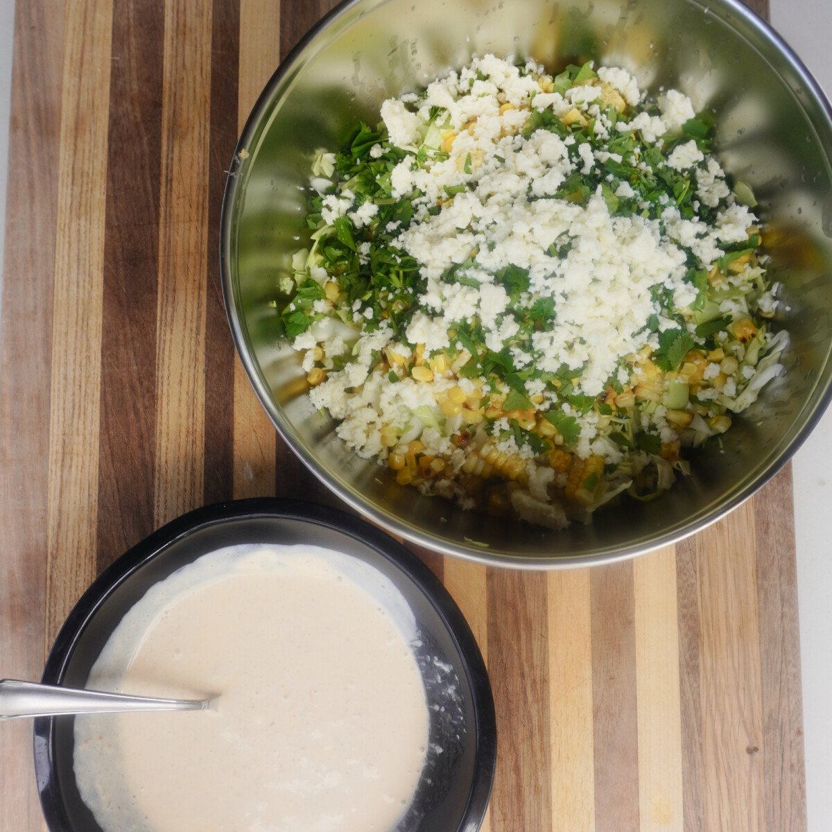corn slaw ingredients. Creamy sauce and cut up veggies.