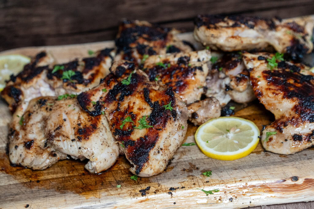 griddle cooked chicken thighs on a wooden board