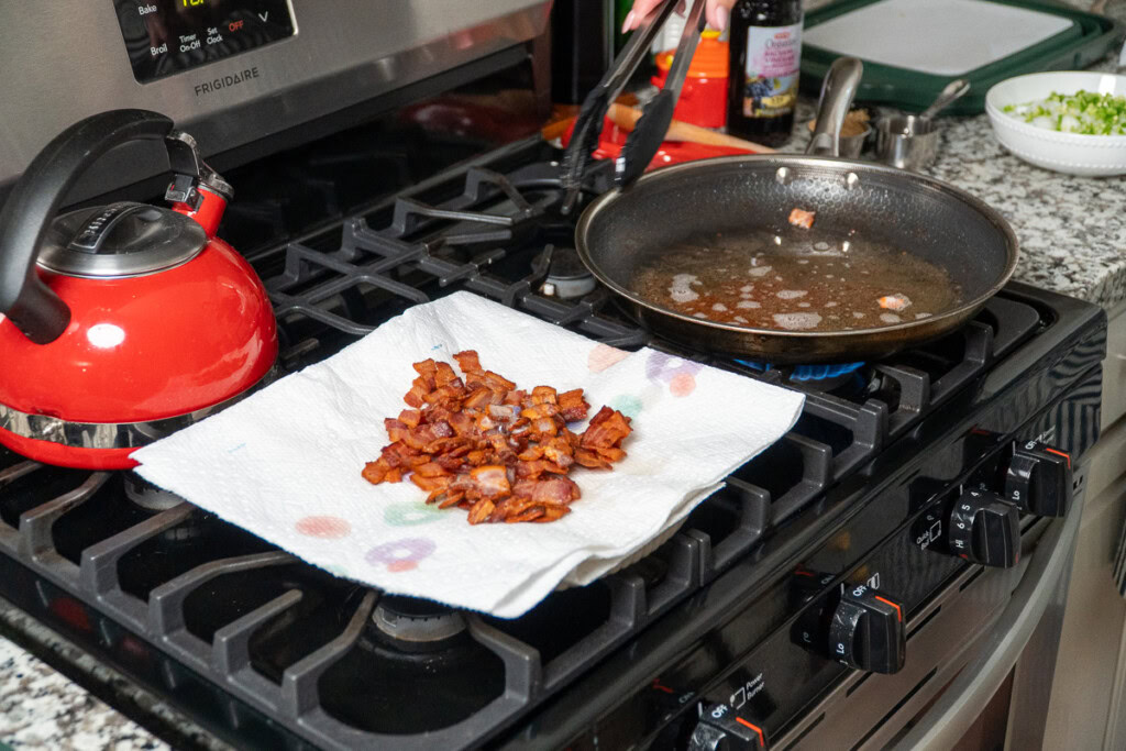 cooked bacon draining on paper towels