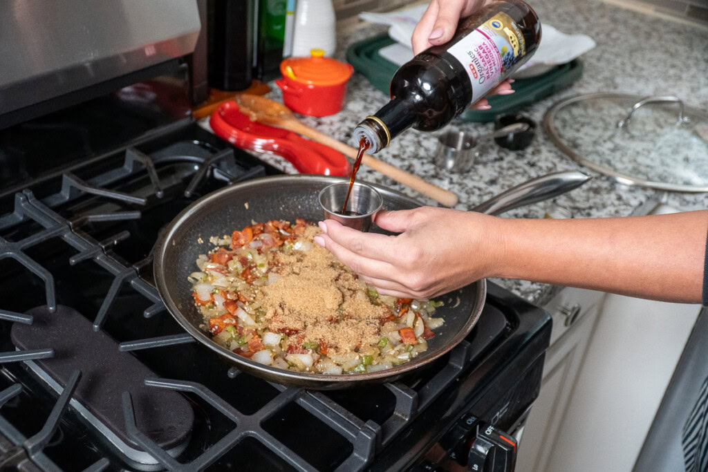 balsamic vinegar being added to the onion bacon mixture