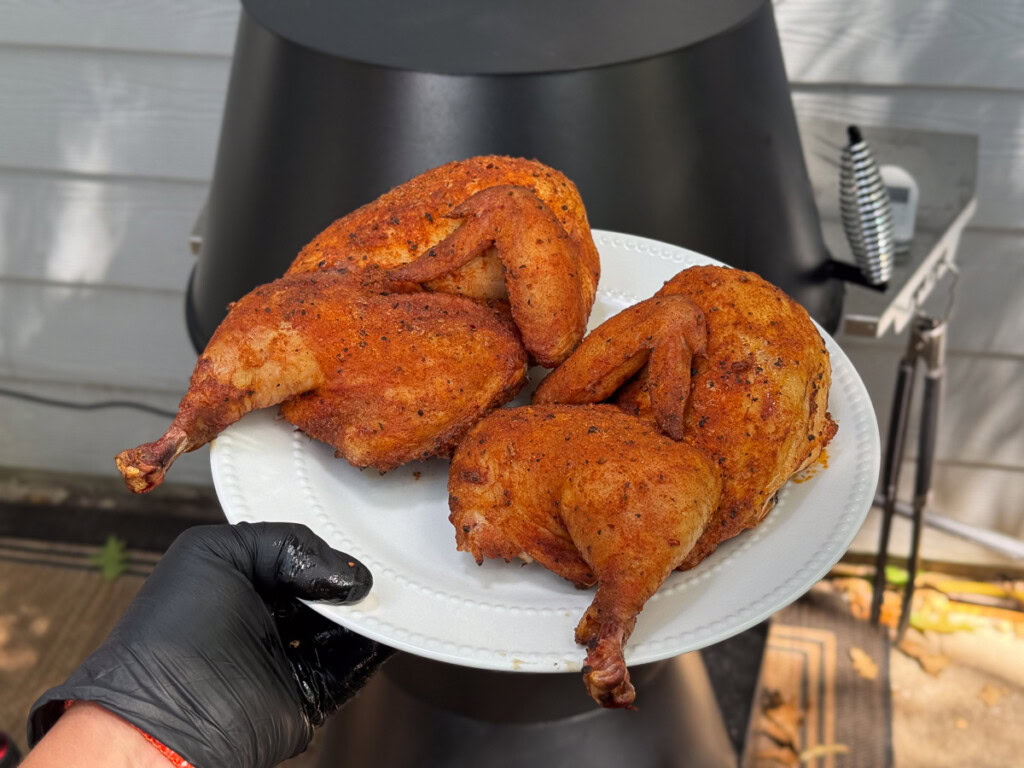 cooked chicken halves on a white plate