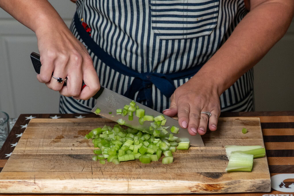 a person dicing celery