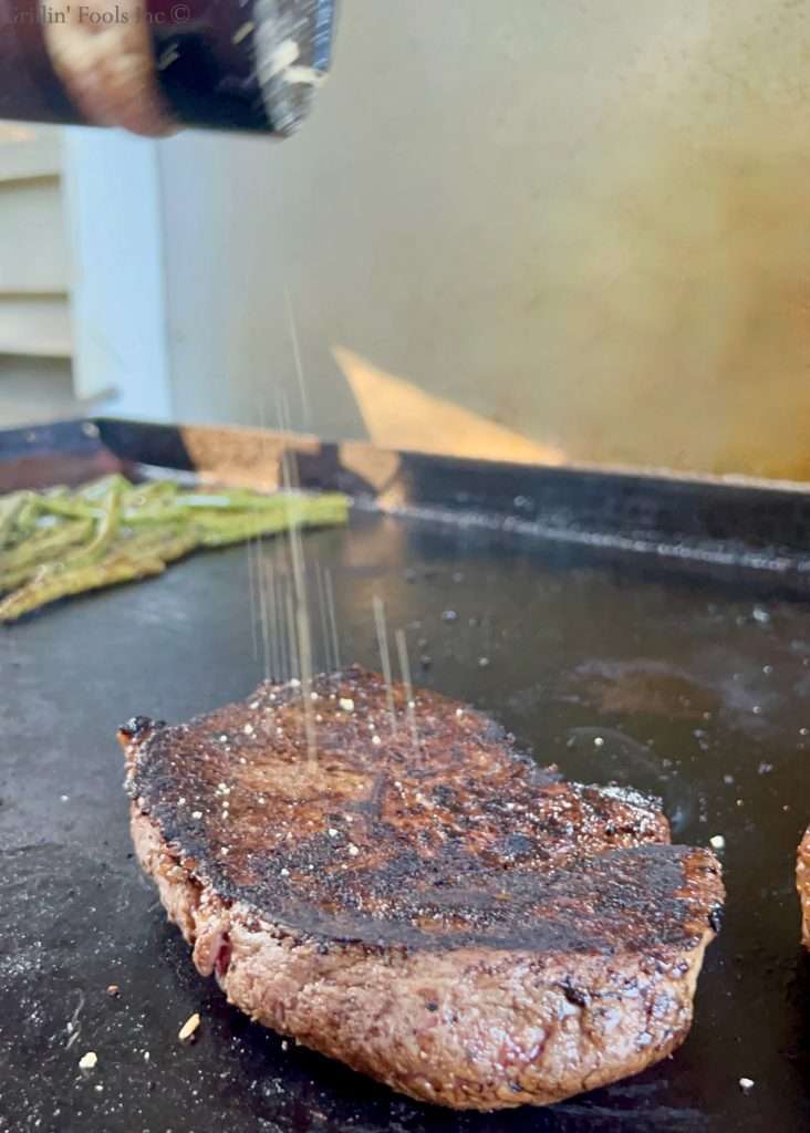 Re-season the grilled sirloin steaks