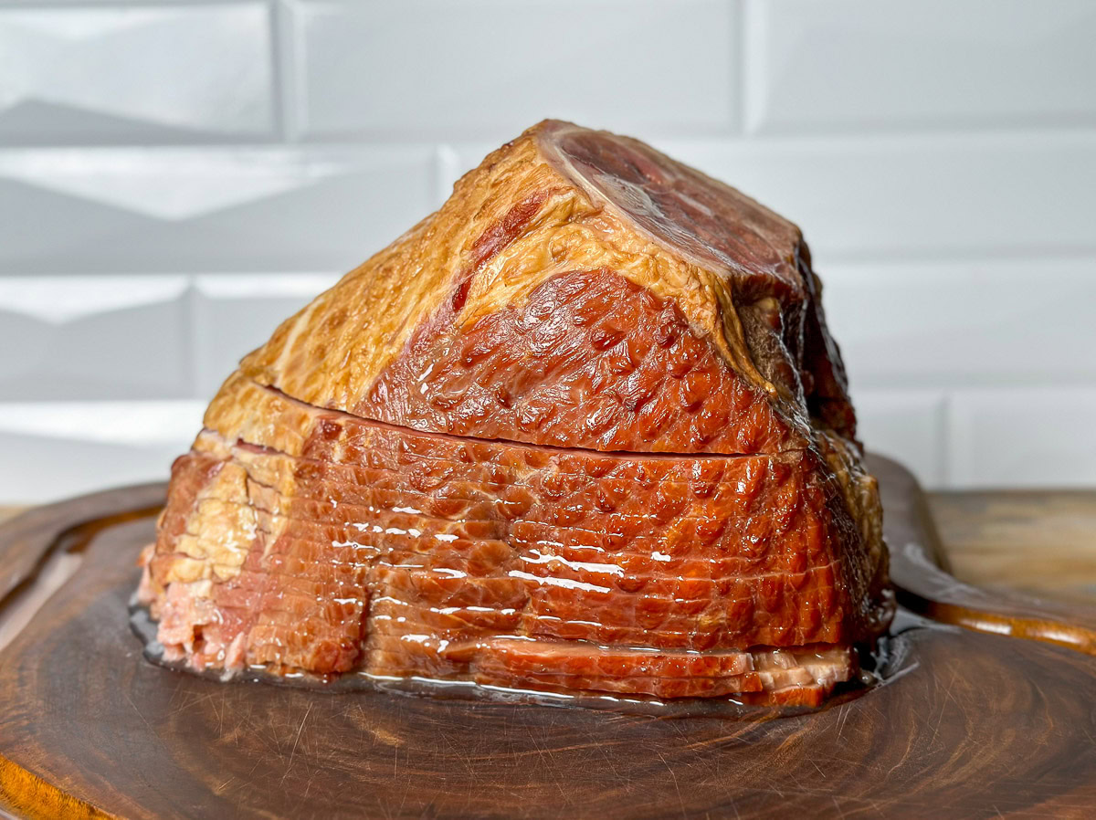a smoked spiral ham on a wooden board