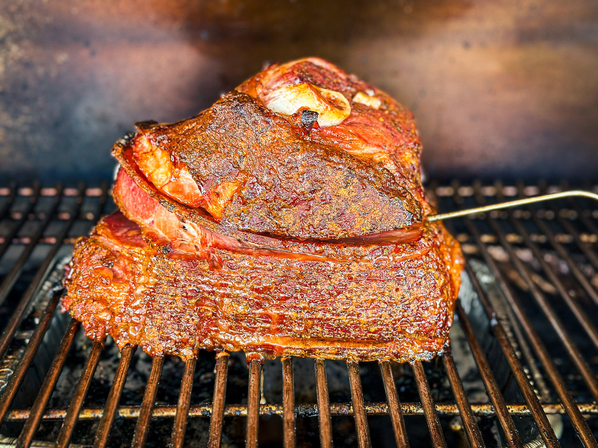 a spiral ham in the smoker with a temperature probe stuck in it