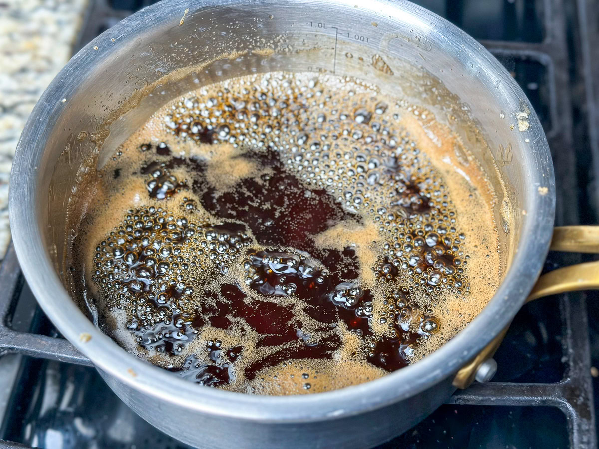 a pot of ham glaze on the smoker