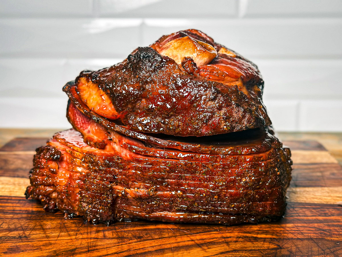 a double smoked spiral ham on a wooden board