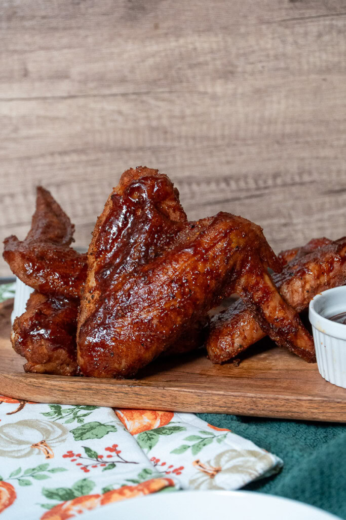 smoked turkey wings plated on a wooden board