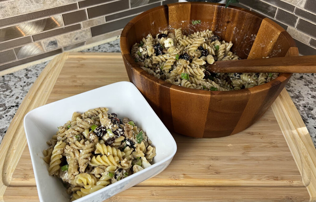 cranberry walnut pasta salad in large bowl and small bowl