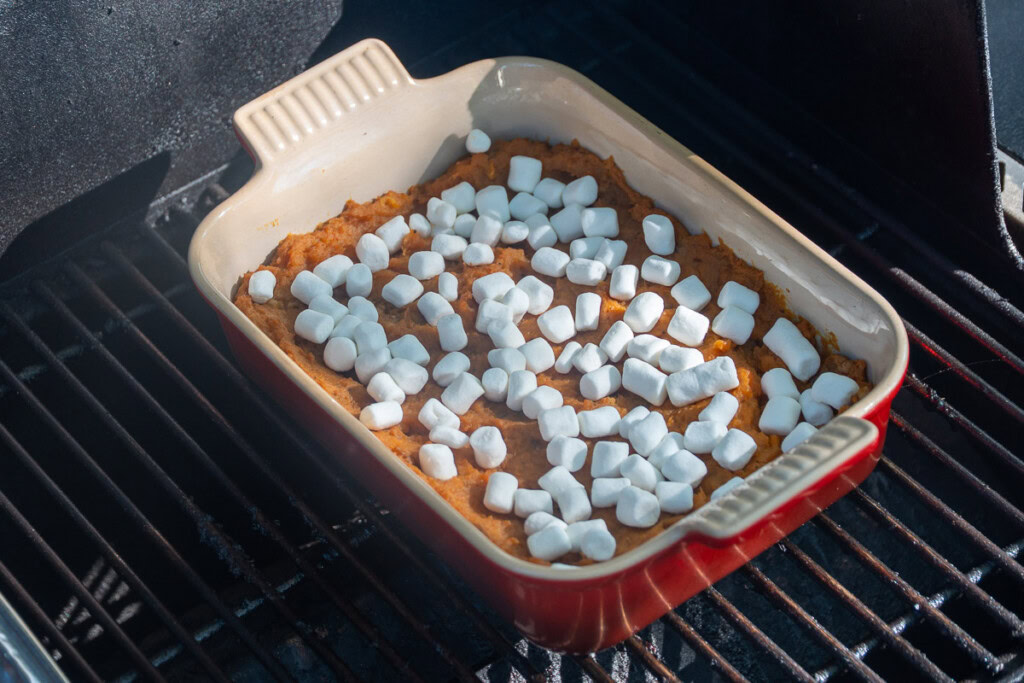 marshmellows sprinkled over the smoked sweet potatoes in the casserole dish