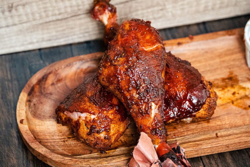 smoked turkey legs on a wooden board