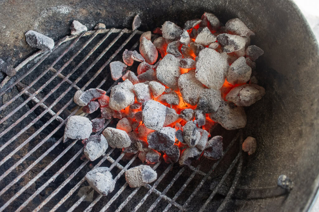 hot coals being dumped into the weber kettle