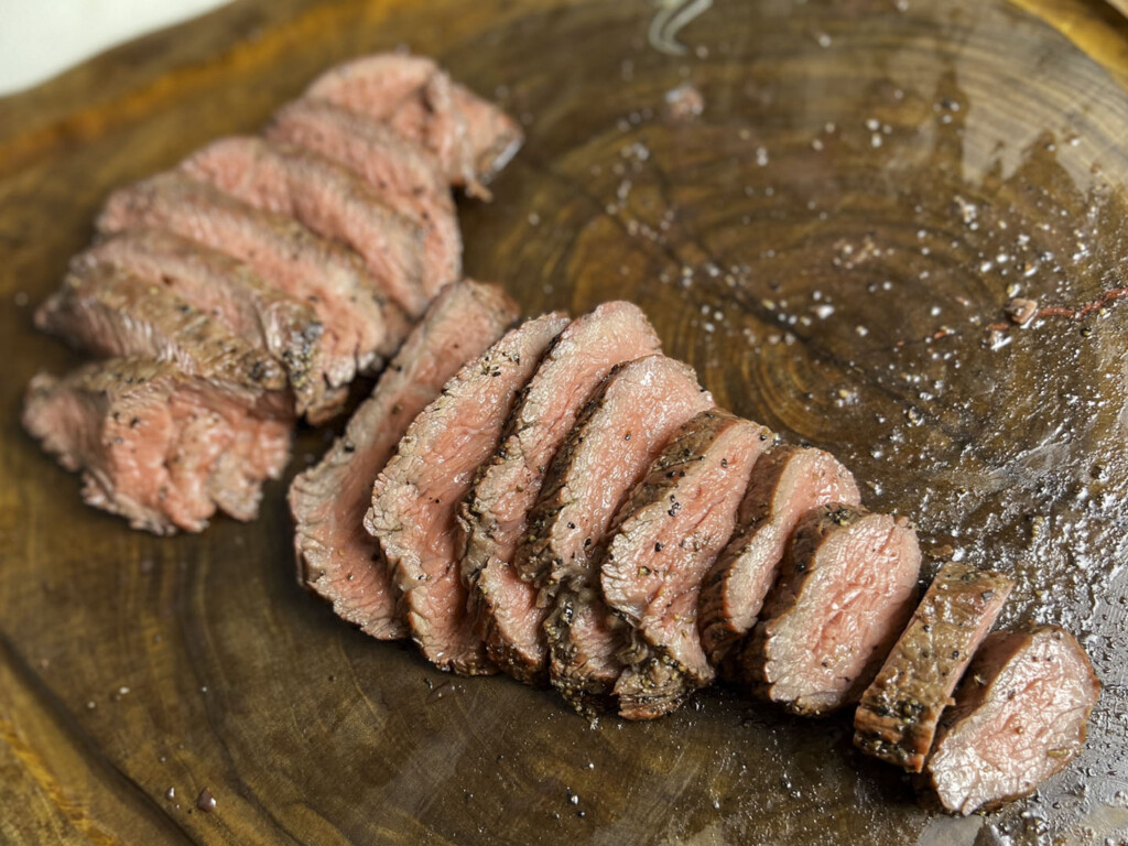 sliced smoked tri tip on butcher block