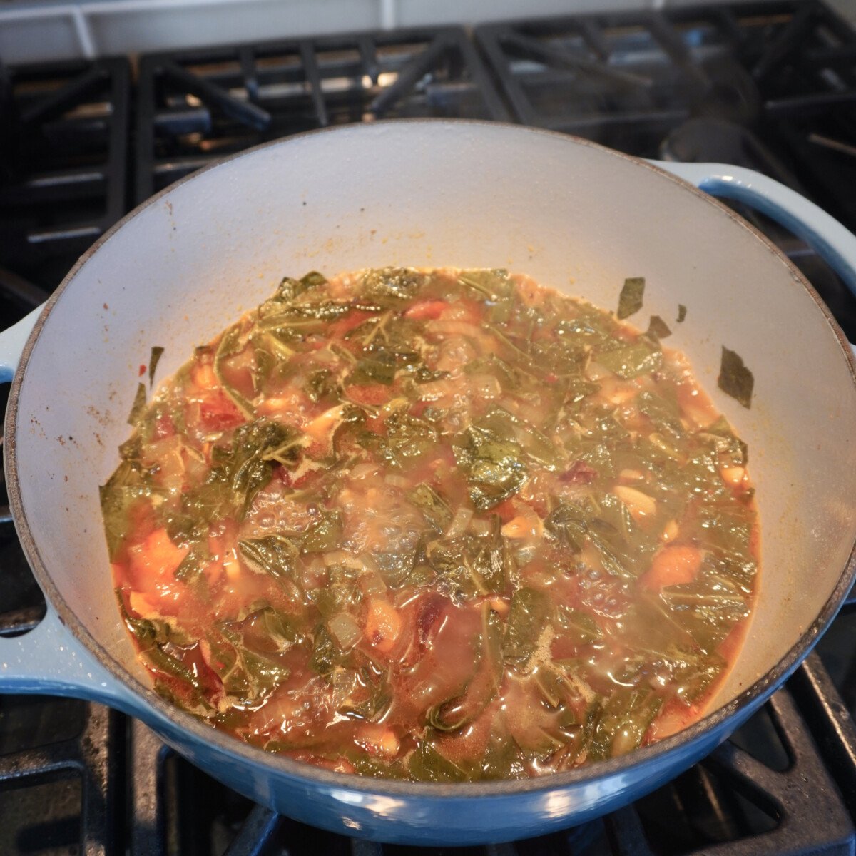 cooked down collard greens and sausage.