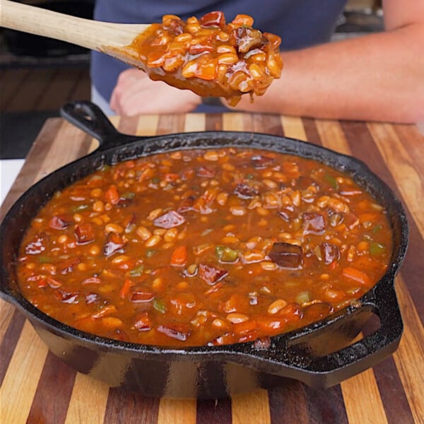 cooked pit beans in skillet on cutting board