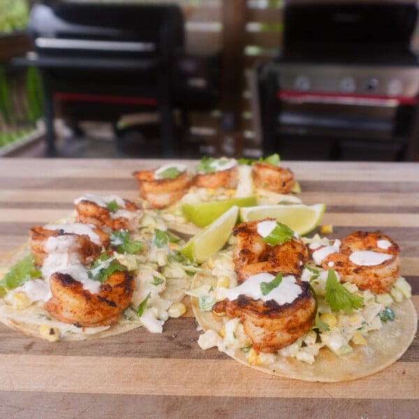 3 grilled shrimp with corn slaw tacos on cutting board