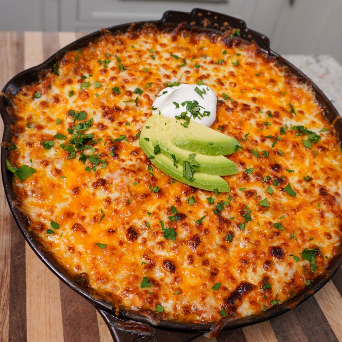 creamy chicken enchilada skillet on cutting board.