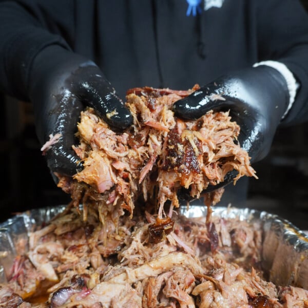 Shredded classic pulled pork in hands.